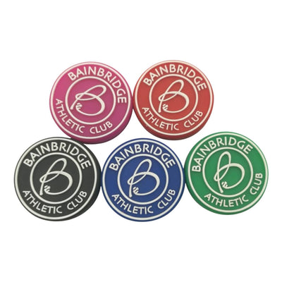 Five custom-made round vibration dampeners with the client's name and logo.