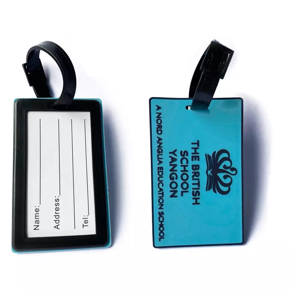Teal custom bag tags showing an address insert card on the front and "The British School Yangon" logo on the back.