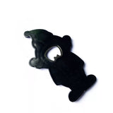 Reverse side of a character-shaped bottle opener showing the metal bottle-opener insert.