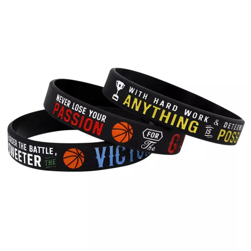 Three black rubber bracelets with inspirational quotes in colored lettering.
