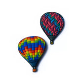 Two custom magnets shaped like colorful patterned hot air balloons.