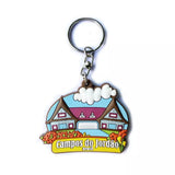 Custom souvenir keychain shaped like a chalet reading "Campos do Jordao, Brasil".