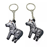 Two custom keychains shaped like a cartoon zebra.