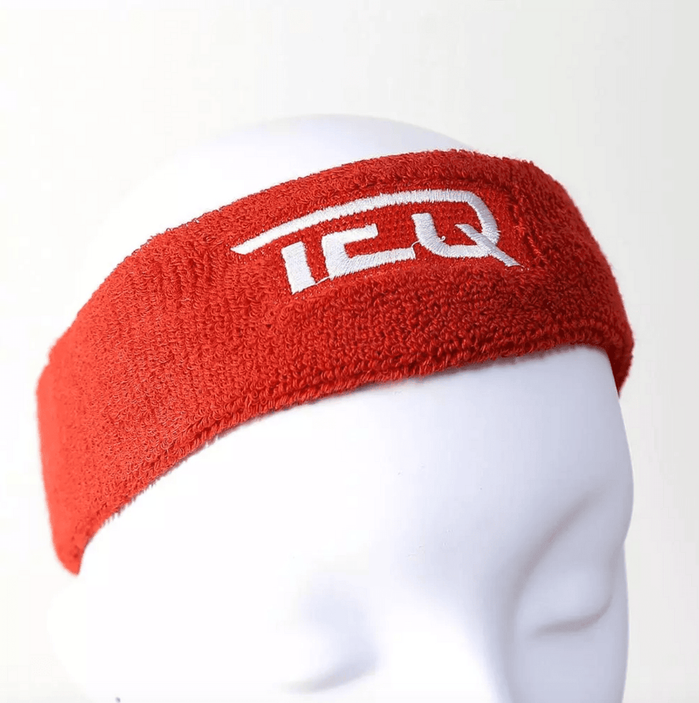 Red custom terry cloth headband embroidered with a white team logo, shown on a mannequin head.