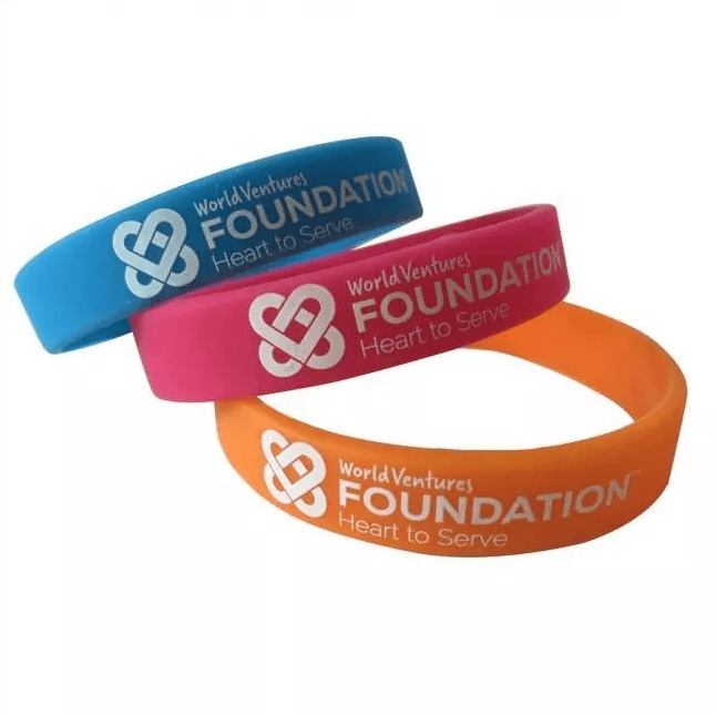 Three custom rubber bracelets with the foundation's name, logo, and motto.