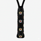 Black custom tennis overgrip printed with repeating multicolored coat-of-arms crests on a racket handle.