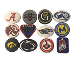 Twelve custom tennis vibration dampeners in varied shapes and designs showing customization options.