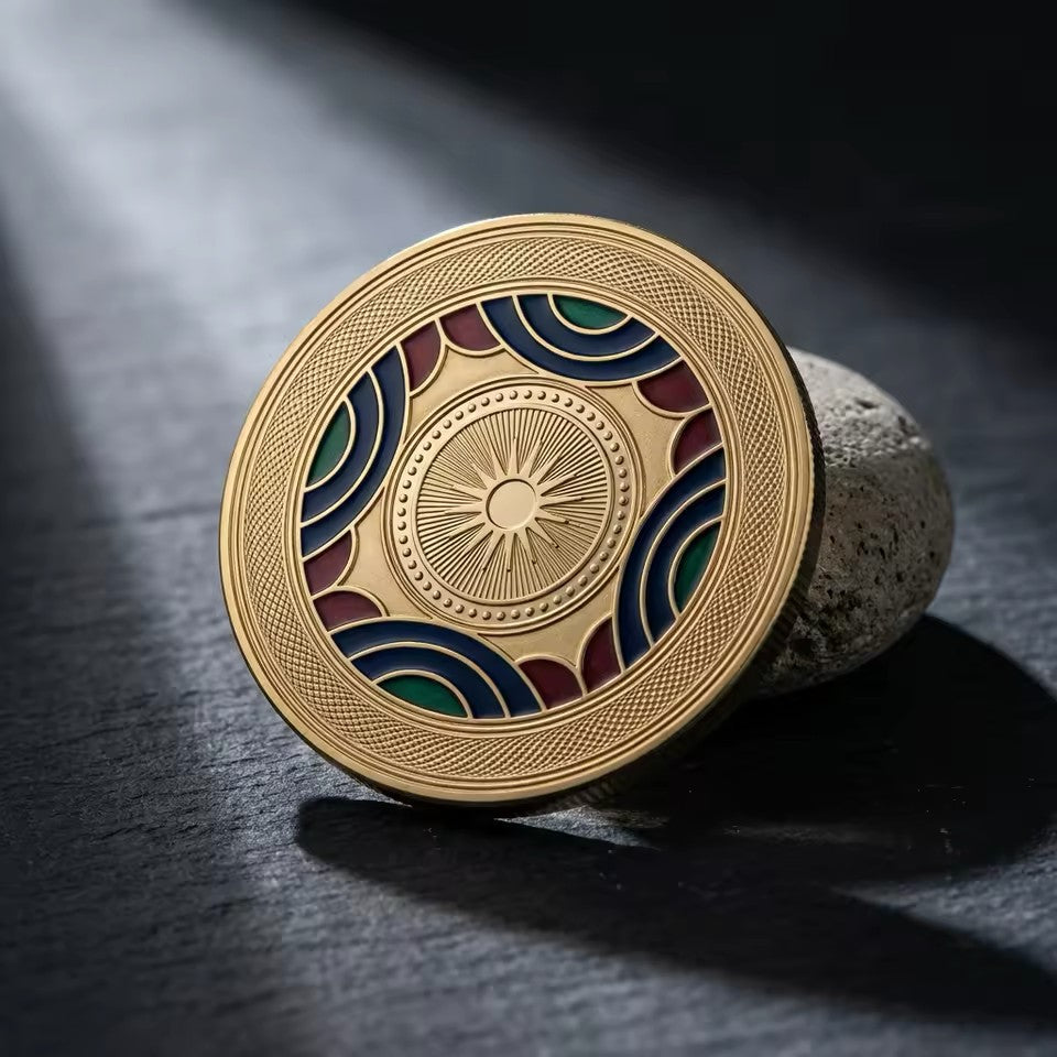 Gold custom challenge coin with navy, red, and green enamel, standing on its edge to show the raised metal design
