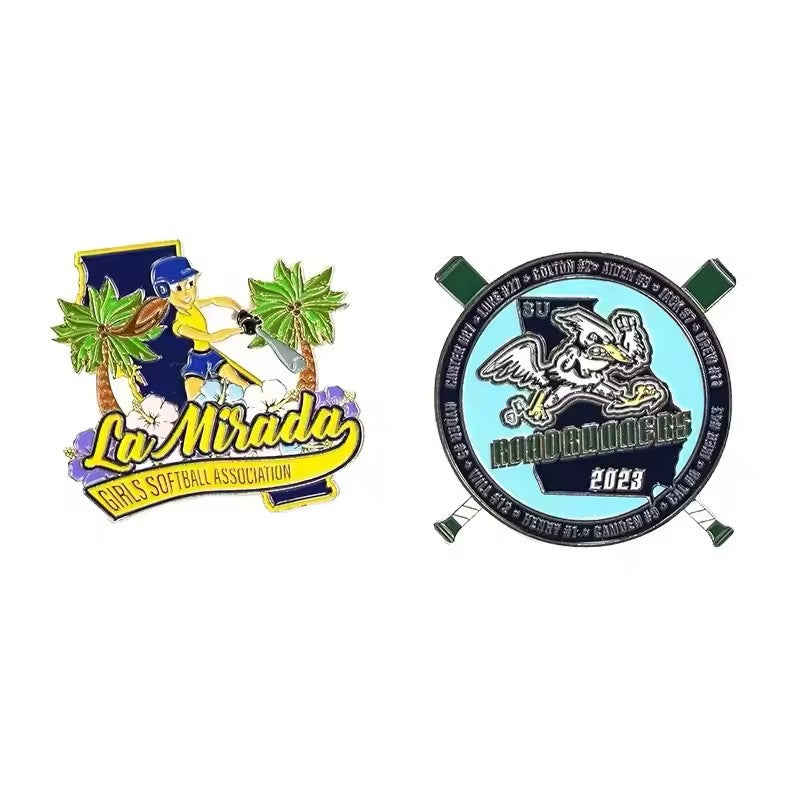 Two custom team trading pins: a girls softball pin cut to the shape of a player and palm trees, and a round baseball pin with a bird mascot and crossed bats