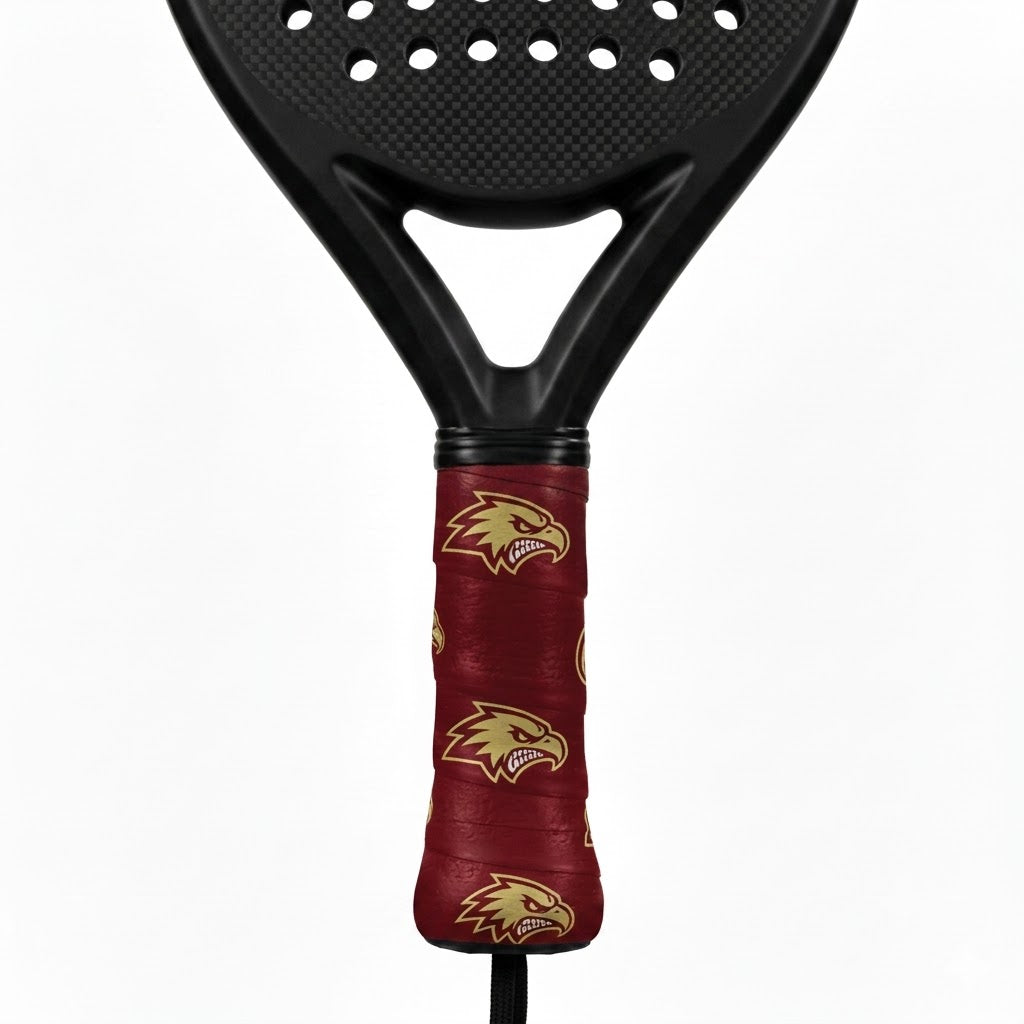 Padel racket with a maroon custom overgrip printed with a repeating gold eagle head logo.