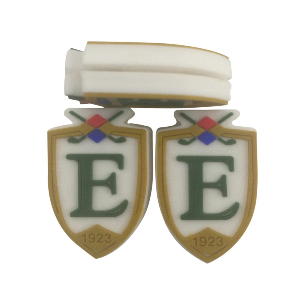 Custom shield-shaped vibration dampeners with the club's logo and founding year.