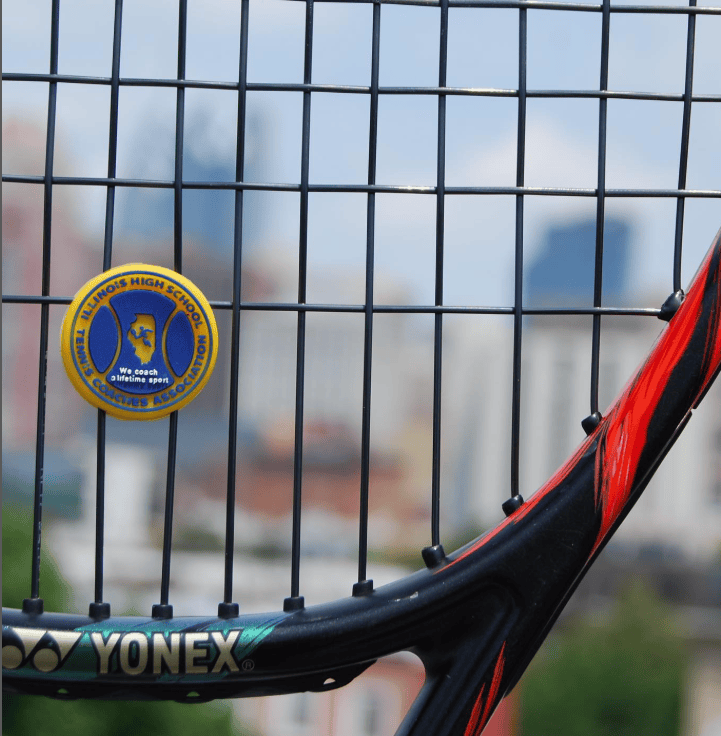 Tennis racket with a custom vibration dampener for a tennis coaches' association.