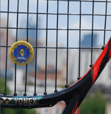 Tennis racket with a custom vibration dampener for a tennis coaches' association.