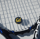 Black and white tennis racket with a custom tennis dampener.